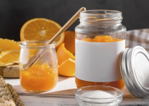 Front view transparent jar with orange jam