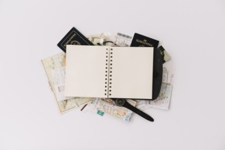 Overhead view blank spiral notebook passport map isolated white background