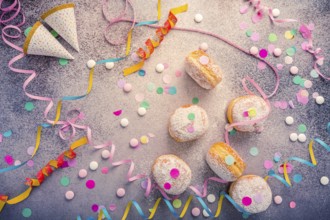 Traditional Berliner for carnival and party. German Krapfen or donuts with streamers and confetti.