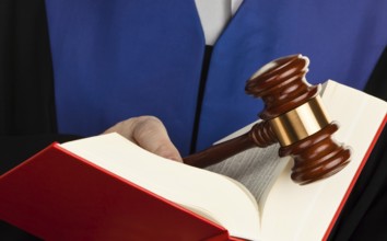 A judge with a law book in court. Gavel in hand, A judge with a law book in court. Gavel in hand.