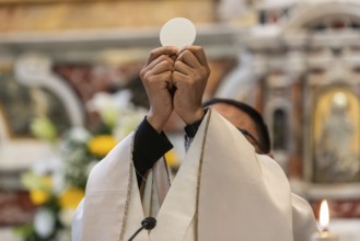 The elevation of the Sacramental Bread during the catholic liturgy