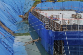 Daejeon, South Korea, August 9, 2020: Foundation for building under construction surrounded by high