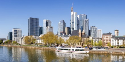 Frankfurt skyline skyscrapers with banks on the river Main with excursion boat panorama in