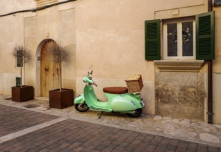 Green Vespa in the old town of Santanyi, Majorca, Balearic Islands, Spain, Europe