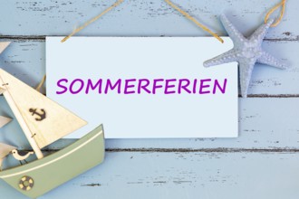 Photomontage: Sign with text SUMMER HOLIDAYS on a blue wooden board with maritime accessories
