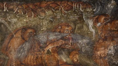 A mural shows grotesque, demonic creatures with grim faces in a menacing scene, Easter 2025, Church