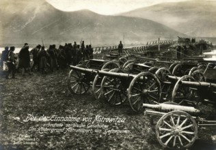 Serbian guns captured during the capture of Mitrovitsa. In the background, transport of prisoners,