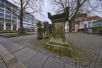 Historic gravestones, general architecture, pavement made of cobblestones and paving slabs, diffuse