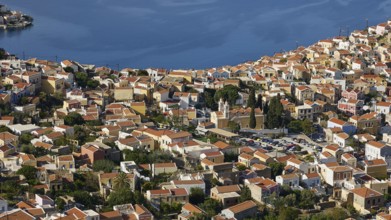 Dense cluster of houses overlooking the sea beyond, Symi Town, Symi, Dodecanese, Greek Islands,