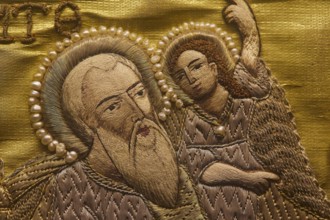 Detailed embroidery of a saint with pearl jewellery on golden fabric, Museum of Icon Painting,