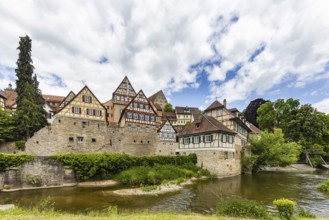 Town view with interesting half-timbered houses on the river Kocher. Historic old town centre of