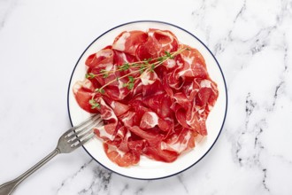 Plate with sliced cured meat, pork neck, prosciutto coppa, Italian delicacy