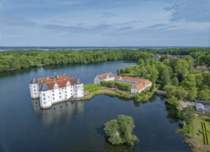 Glücksburg Castle and the castle pond. The lake is part of the Munkbrarupau stream. Aerial view.