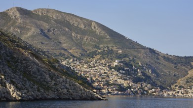 Coastal town on mountainous shores, Symi Town, Symi, Dodecanese, Greek Islands, Greece, Europe