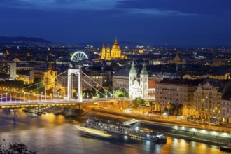Evening panorama of Budapest with the Danube and the Elisabeth Bridge. The illuminated church in