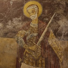 Saint with armour and halo, holding a weapon on an old church wall, Monastery Thari, Moni Thari,