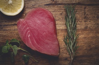 Fresh red tuna fillet, for steak, raw, top view, on a cutting board, no people