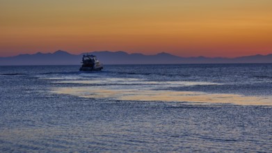 Lonely boat on the sea with mountains in the background, sunrise, dawn, Fort of Saint Nikolaos,