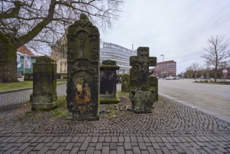 Historical gravestones, general architecture, pavement made of cobblestones, diffuse light, cloudy,