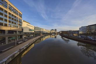 River Saar, modern architecture, trees, reflections on the water surface, fashion shop, Primark,