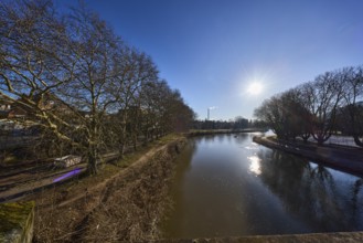 River Saar, bank, trees, meadow, abstract reflections, water surface, backlight of the sun, blue