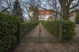 Moated castle with entrance gate, originally a manor house, converted into a Renaissance castle