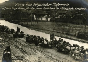 Short rest of Bulgarian infantry on their way through Albania, having their lunch while crouching,