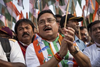 People holding Indian national flags as they take part in a rally, in soliderity with the Indian