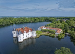Glücksburg Castle and the castle pond. The lake is part of the Munkbrarupau stream. Aerial view.