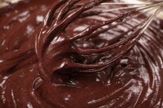 A bowl of chocolate dough, a whisk for whipping, baking, structure and consistency, homemade, top