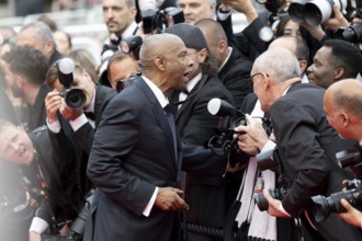Cannes, France - 19.5.2024: Denzel Washington talks to photographers during the - Highest 2 Lowest