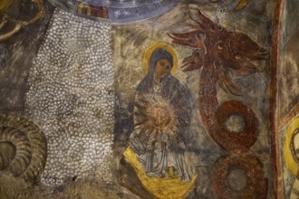 The fresco shows Mary next to a dragon-like creature with intense symbolism in a medieval context,