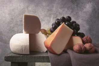 Georgian cheese, Imeretian and smoked suluguni, grapes, nuts, on a cutting board, Georgian cuisine,