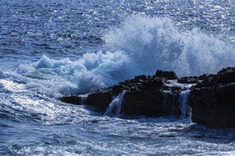 Rugged rocky coastline and foaming spray, on Stecci beach, near Capoliveri, Elba Island, Tuscan