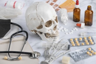 Medical scenario with skull, stethoscope and pills