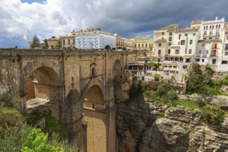 The imposing Puente Nuevo bridge in Ronda, which crosses a deep ravine, surrounded by historic