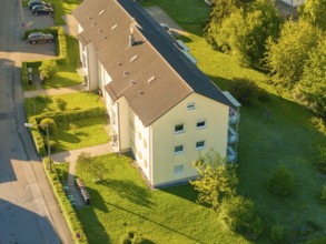 Apartment house surrounded by green lawns and trees on a sunny day, Calw, Black Forest, Germany,
