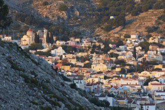 A picturesque hilltop village with traditional stone houses and a summery atmosphere, Symi Town,