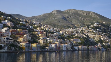 Coastal town with mountain views and water, Symi Town, Symi, Dodecanese, Greek Islands, Greece,