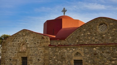 An old church with a red roof and a cross in front of a clear blue sky, Easter 2025, Church of the
