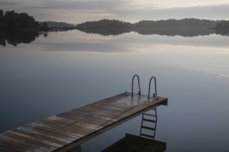 Wooden jetty with ladder, calm water surface, morning atmosphere, Kasnäsintie, Falkö Fjord, Kasnäs,