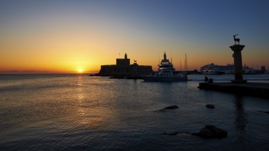Harbour with boats and fortress, sunrise, dawn, Fort of Saint Nikolaos, Mandraki Harbour, Rhodes