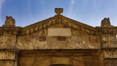 Synagogue, stone facade of an ancient building with inscription under a clear sky, Rhodes Old Town,