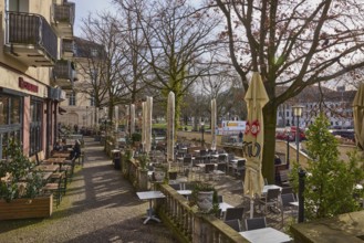 Aresto - Greek restaurant, outdoor area of a catering establishment with tables, chairs and
