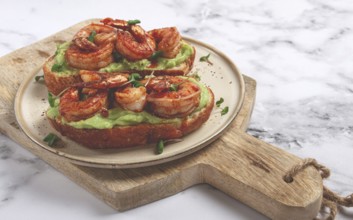Sandwiches with avocado and caramelized shrimp, micro-greens, breakfast, on a plate, top view,