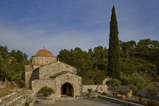 Stone church with cypress in front of a wooded background, Monastery Thari, Moni Thari, near