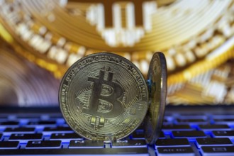 Symbolic bitcoins on a laptop