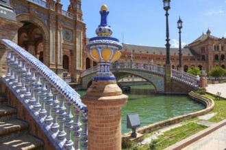 Close-up of a tiled bridge at the Plaza de España in Seville with water in the background, Seville,