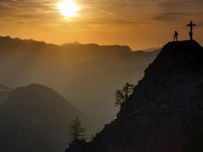 Mountaineers at the summit cross of the Kleiner Jenner at sunset, Reiteralpe in the background,