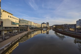 River Saar, modern architecture, trees, reflections on the water surface, fashion shop, Primark,